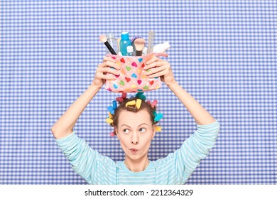 Portrait Of Funny Young Woman With Colorful Hair Curlers On Head, Holding Makeup Bag With Beauty Treatment Accessories And Cosmetics, Making Goofy Face, Fooling Arounds Over Shower Curtain Background