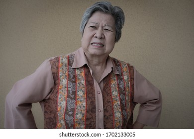 Portrait Of Furious Elder Woman. Enraged Elderly Female. Angry Asian Senior