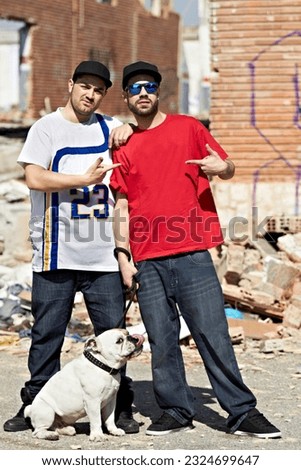 Portrait, gang and dog with man friends and their pet outdoor in a dangerous neighborhood together. Street, crime and culture with male gangsters and their bulldog puppy on an urban background