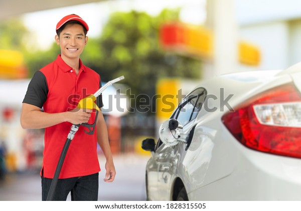 Portrait of Gas station worker and service at the\
gas station