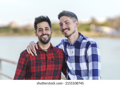 Portrait Of Gay Couple Embracing By A River