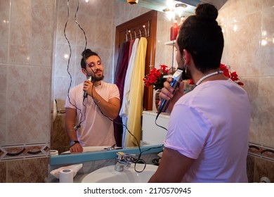 Portrait Of Gay Man Shaving In The Mirror At House Getting Ready For A Date