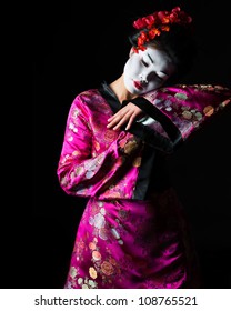 Portrait of geisha dancing isolated on black