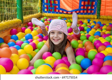 Portrait of a girl in balls on a playground.
 - Shutterstock ID 697175014