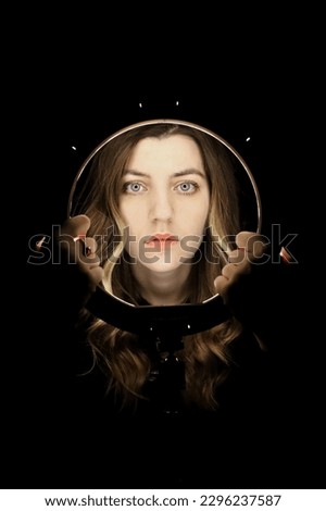 Similar – Artistic portrait of a brunette woman with a light effect