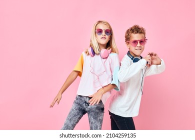 Portrait of a girl and a boy wearing headphones posing casual kids fashion