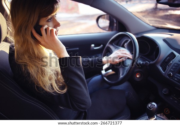 portrait of a girl\
in a car driver at the\
wheel