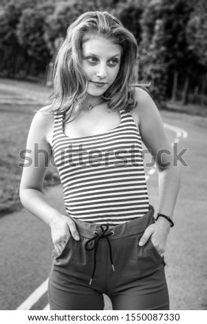 Portrait of a girl in a casual style outdoors. Young beautiful blond woman. Black white photo