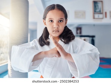 Portrait, girl or child with martial arts for fitness, strength development and energy for training. Class, student or hand gesture in studio for karate, kung fu or defense skills with fight exercise - Powered by Shutterstock