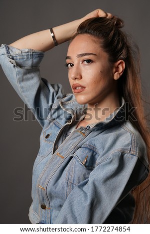 portrait of girl with denim jacket and jeans in the studio