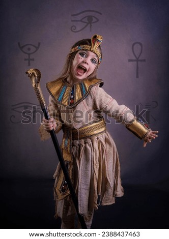 Portrait of a girl disguised as an Egyptian mummy in a studio