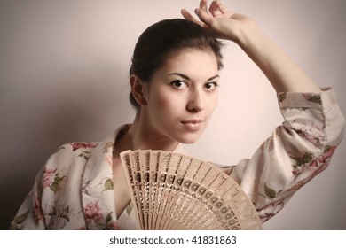 Portrait Of The Girl In East Dressing Gown And A Fan In A Hand.