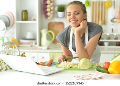 Portrait of girl eating salad on kitchen