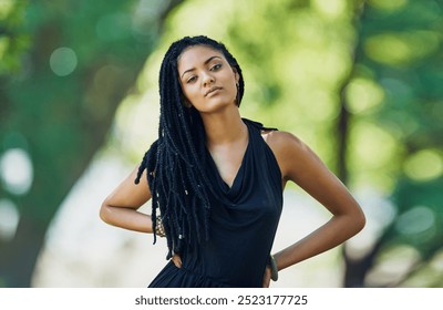 Portrait, girl and fashion with braids outdoor for trendy clothes, cool jewellery or confidence of natural hair. Pride, woman and dreadlocks with creative outfit, unique accessories and culture style - Powered by Shutterstock