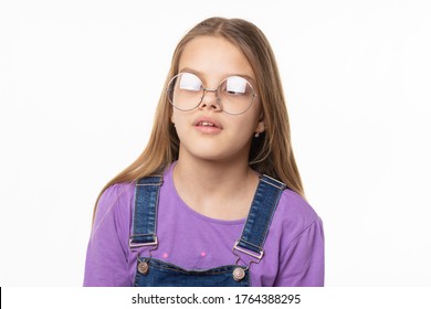 Portrait Of A Girl In Glare Glasses Trying To Look At Her Nose