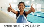 Portrait, girl and happy with thumbs up at swimming center for training, workout and practice for child development. Female person, agree and smile or confident for sports challenge and tournament