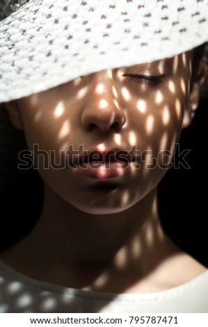 Similar – Image, Stock Photo Shadows of a blind fall on the face of a woman