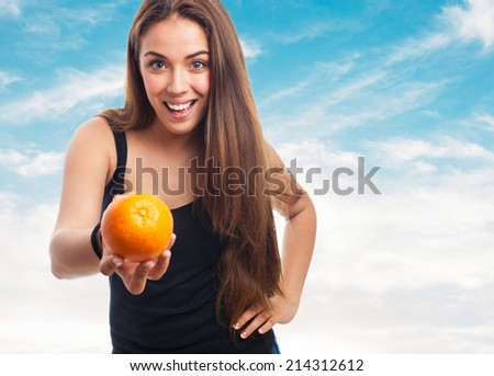 portrait of a girl holding an orange