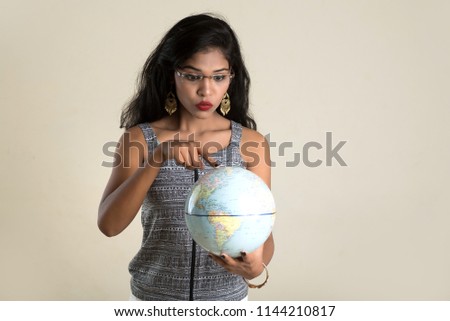 Portrait of Girl holding a world globe.