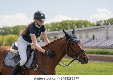 Portrait of a girl jockey riding a horse.  - Powered by Shutterstock