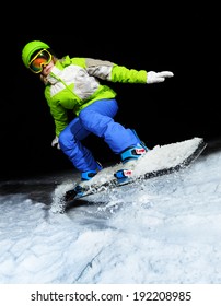 Portrait Of Girl Jumping On Snowboard At Night