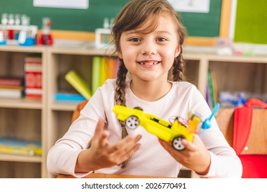 Portrait The Girl Kid With Diy Robot On Stem Education Class. The Students Study Programming Electric Toys At Robotics Classroom On Elementary School. Back To School Concept