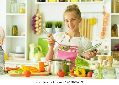 Portrait Of Girl In The Kitchen Preparing To Eat