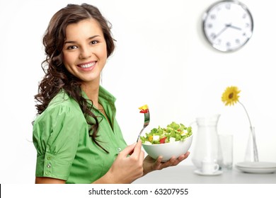 Portrait of a girl looking positive and holding a bawl with salad - Powered by Shutterstock