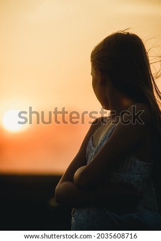 portrait of a girl looking at the sunset