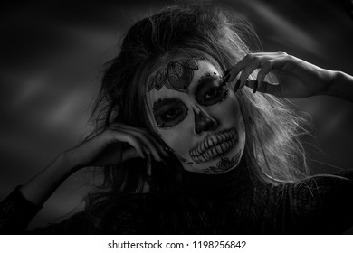Portrait of a girl with a make-up dead man on Halloween. Black and white photo