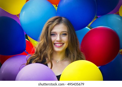 Portrait of girl in many colorful balloons