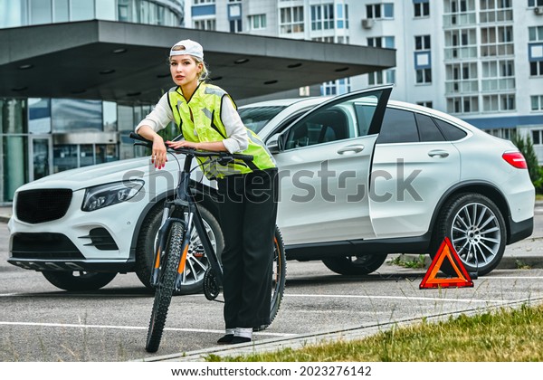 portrait of a\
girl on bicycle in an emergency\
vest