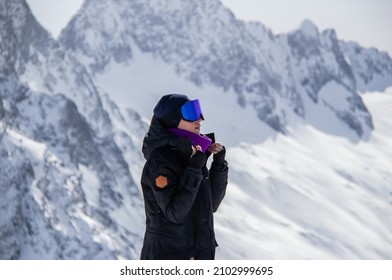 Portrait of a girl on top of a snowy mountain.