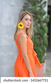 Portrait Of Girl With Orange Dress In The Street