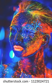 Portrait of a girl painted in fluorescent powder.