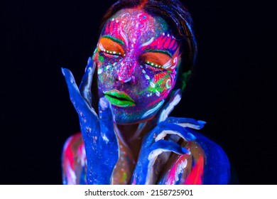 Portrait of a girl painted in fluorescent powder. - Shutterstock ID 2158725901