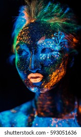 Portrait of a girl painted in fluorescent powder.