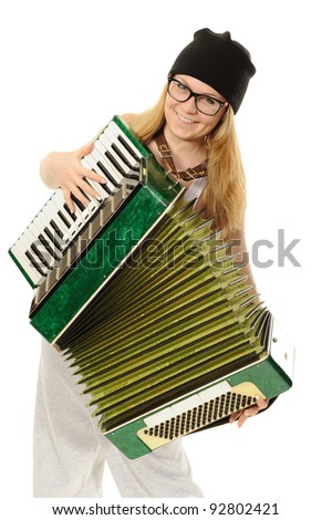 Portrait of the girl, playing an accordion in a cap and glasses