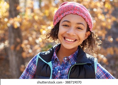 Portrait Of Girl Playing In Autumn Woods