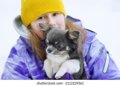   Portrait Of A Girl With Puppy Chihuahua. Friendship Between Animals And People. Cute Pets. Winter Season. Cold Weather.            