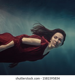      Portrait of a girl in a red dress under water                           - Powered by Shutterstock