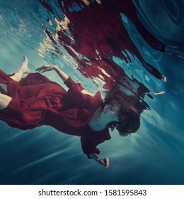      Portrait of a girl in a red dress under water                           - Powered by Shutterstock