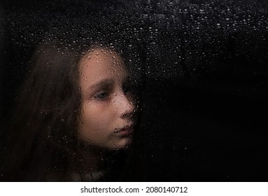 Portrait Of A Girl With A Reflection On A Dark Background By The Window
