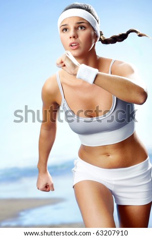 Portrait of a girl running against beach background