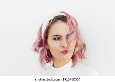 Portrait Of Girl With Short Wavy Pink Hair And White Headband On