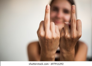 Portrait of girl showing middle fingers on hands