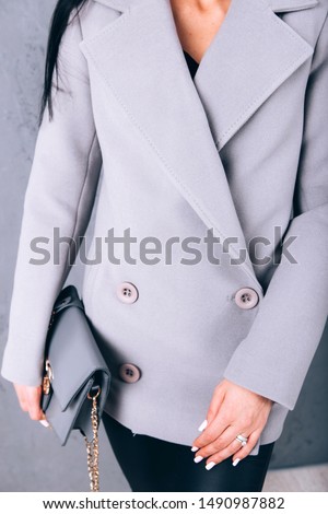 portrait of a girl in the studio. fashionable outerwear. beautiful business autumn trend, hands closeup, detail. spring autumn collection. woman wear business style clothing for office casual