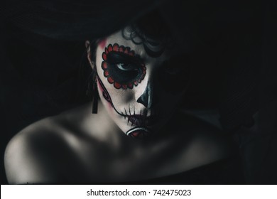 Portrait of a girl with sugar skull makeup over black background. Calavera Catrina. Dia de los muertos. Day of The Dead. Halloween.  