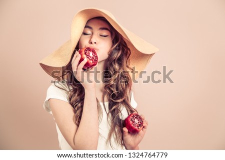 Portrait of a girl in a summer hat with fruit in her hands, concept of style and summer days