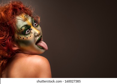 A Portrait Of A Girl With Ugly Halloween Frog Or Toad Tattoo Painted On Her Face As A Mask.